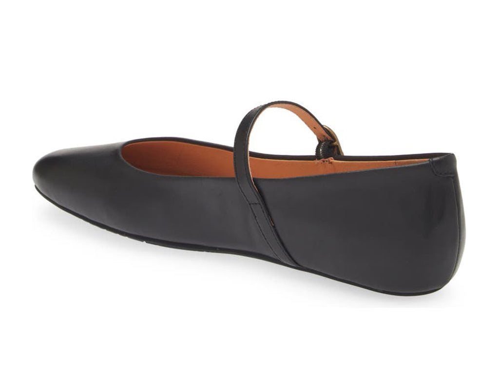 Black leather rounded toe flat with over the instep buckle strap on a white background side angle view