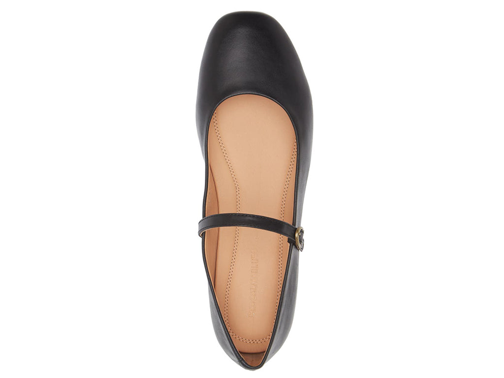 Black leather rounded toe flat with over the instep buckle strap on a white background top view