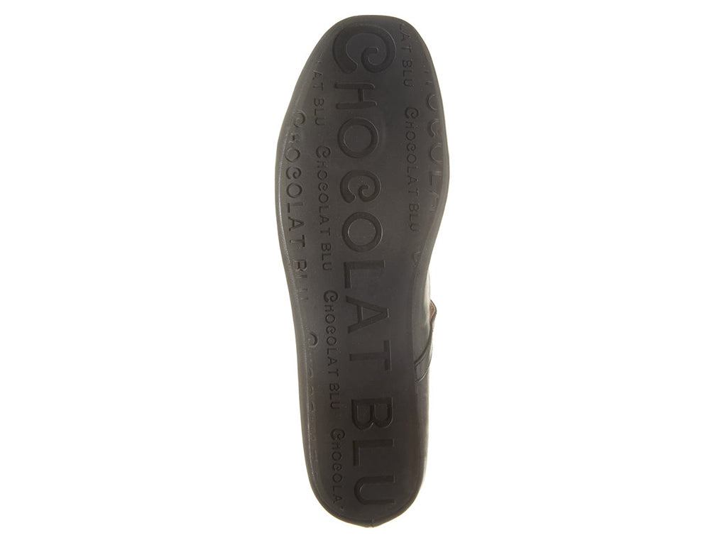 Black leather rounded toe flat with over the instep buckle strap on a white background bottome sole view