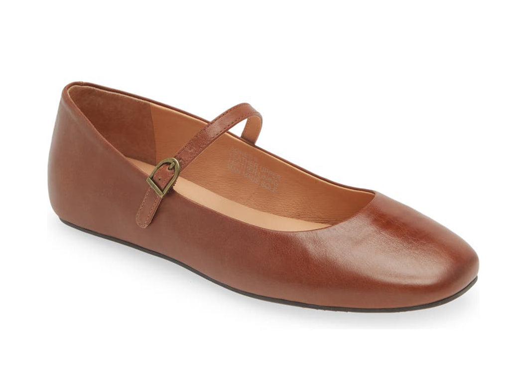 Brown leather rounded toe flat with over the instep buckle strap on a white background side angle view