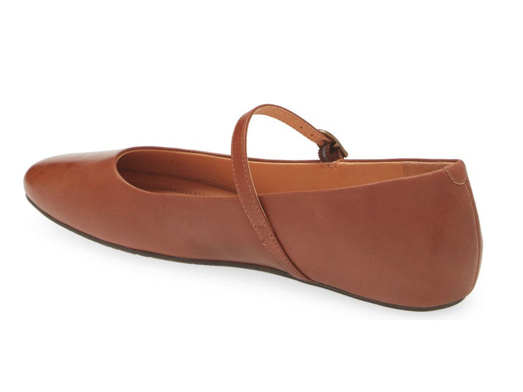 Brown leather rounded toe flat with over the instep buckle strap on a white background side angle view