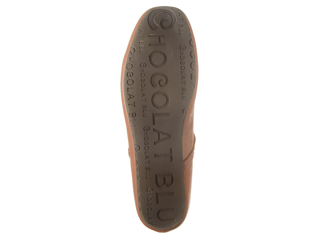 Brown leather rounded toe flat with over the instep buckle strap on a white background bottom sole view