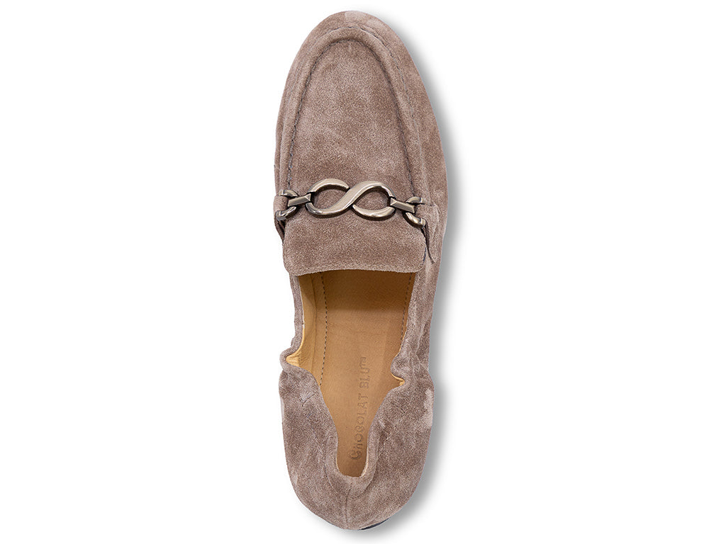 A toffee suede loafer with a decorative metal horsebit detail across the vamp - top view