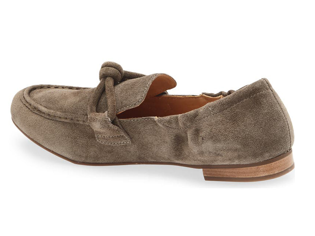 Dark tauoe suede rounded toe flat with decorative cord design and elasticized sides on a white background side angle view