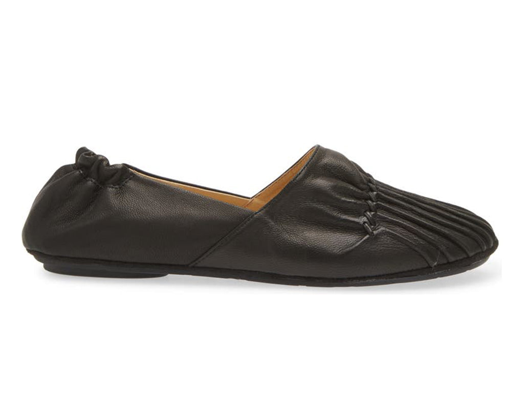 Black leather rounded toe flat with ruched design and elasticized back on a white background side view