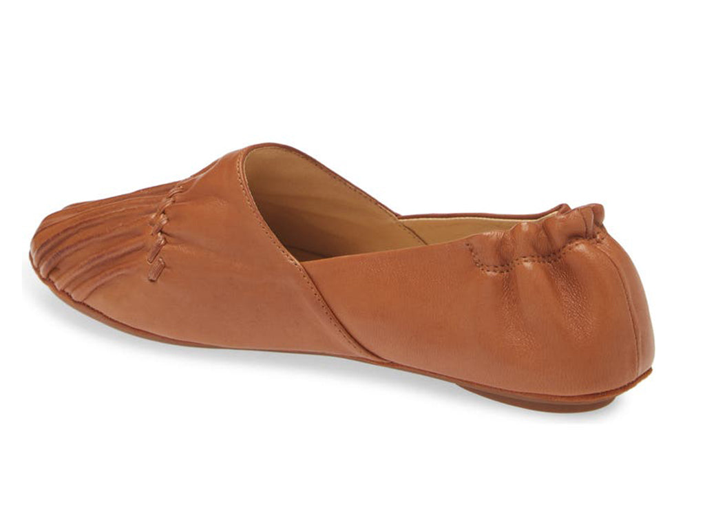 Camel leather rounded toe flat with ruched design and elasticized back on a white background side angle view