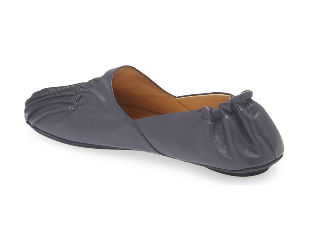 Navy leather rounded toe flat with ruched design and elasticized back on a white background side angle view