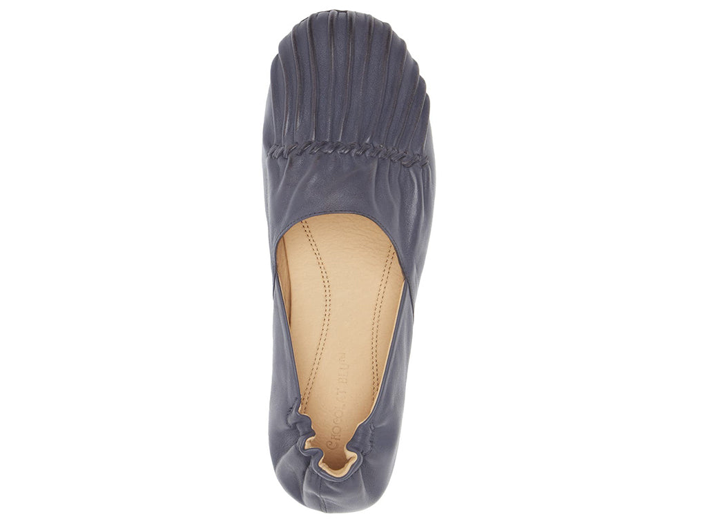 Navy leather rounded toe flat with ruched design and elasticized back on a white background top view