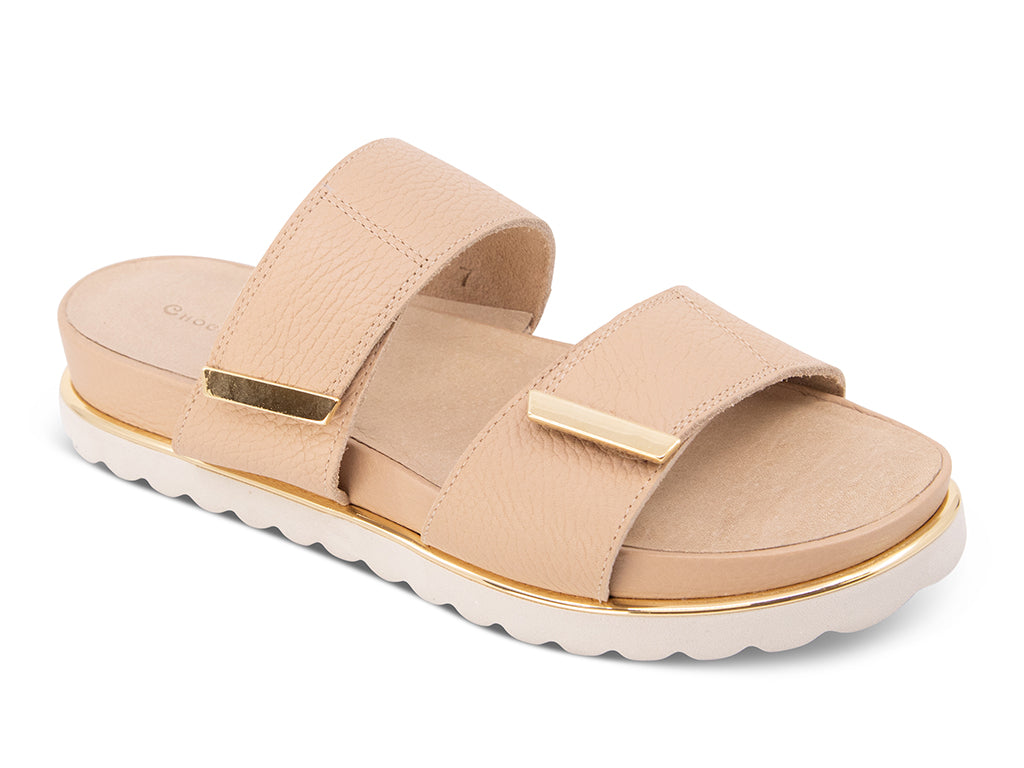 cream sandal with a white track sole and gold accents 