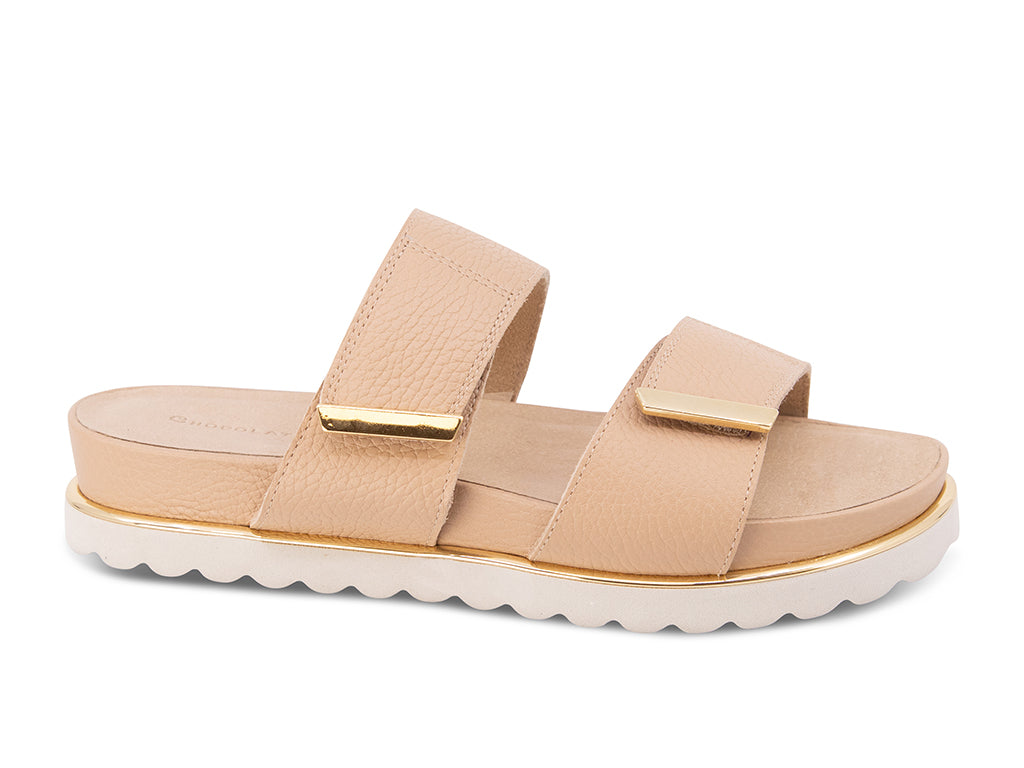 cream sandal with a white track sole and gold accents - side view