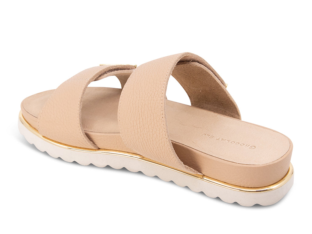 cream sandal with a white track sole and gold accents - view from the back