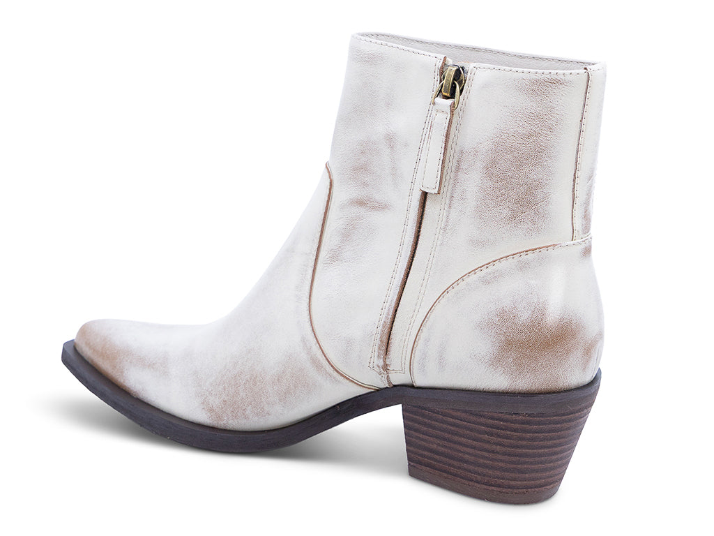 A vintage white leather ankle boot with a pointed toe and a low block heel - inner side view