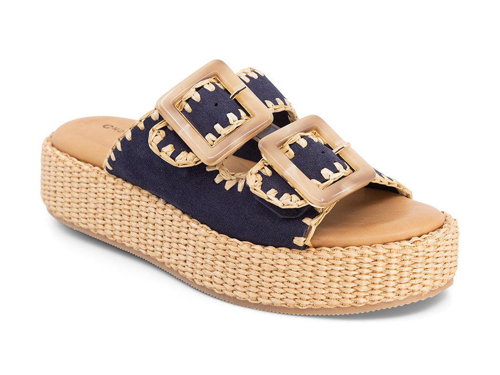 blue suede upper sandal with buckles on a raffia wrapped platform 