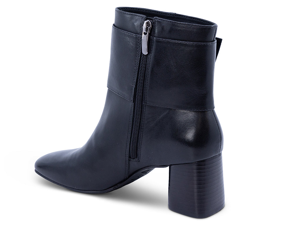 A black leather ankle boot with a square toe, a block heel, and a wide strap with a rectangular buckle - inner side view