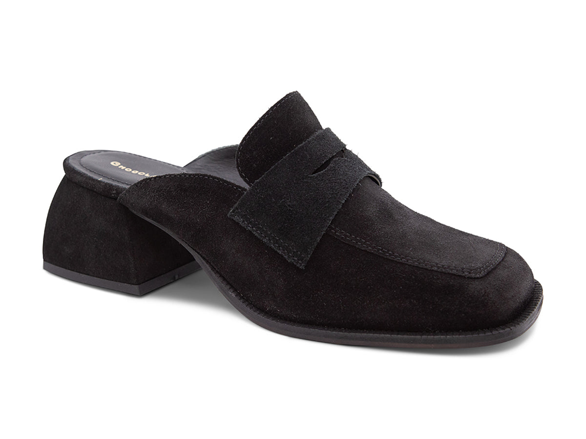 Black suede slide shoe with a block heel and penny loafer design on a white background side angle view