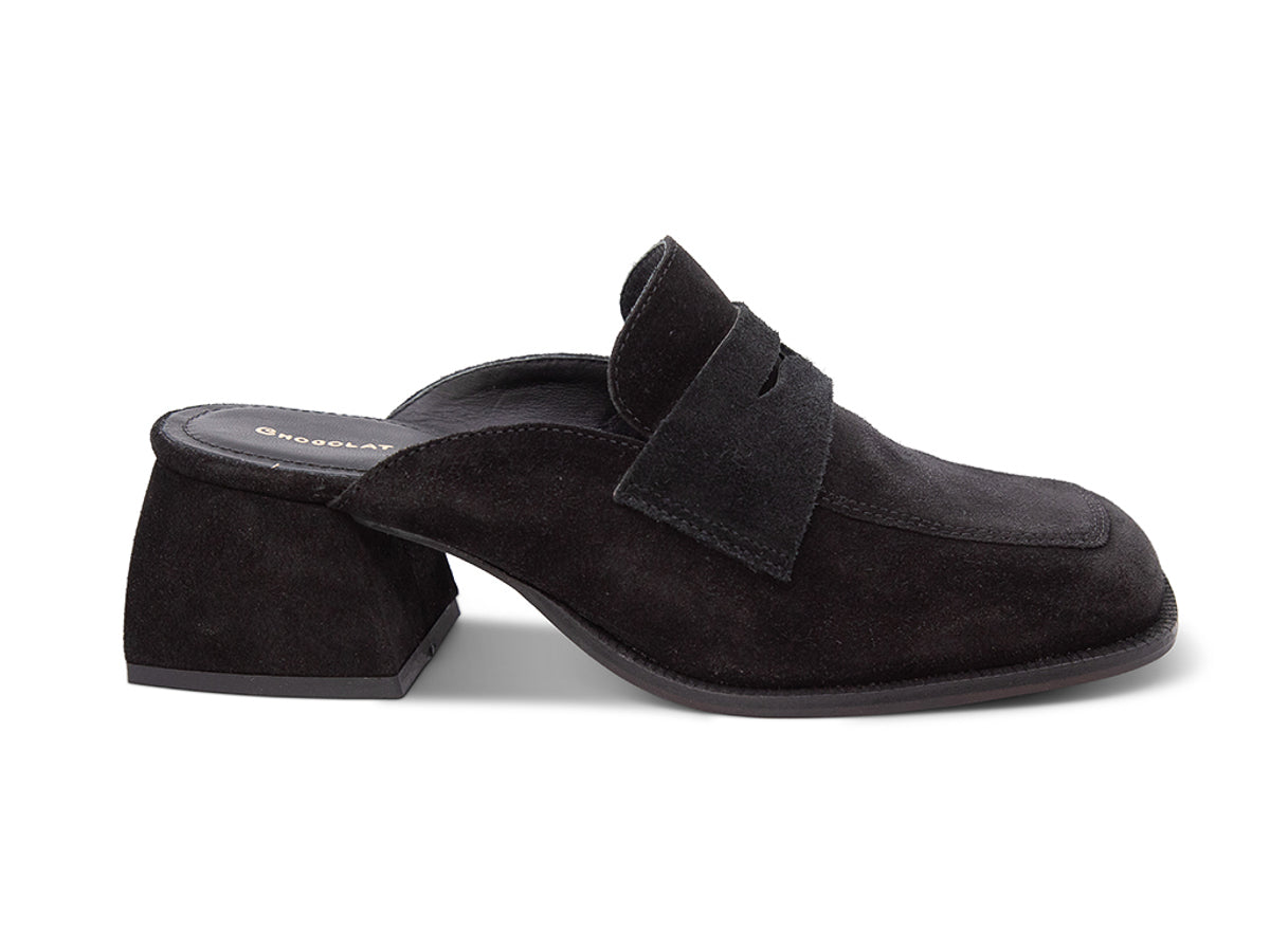 Black suede slide shoe with a block heel and penny loafer design on a white background side view