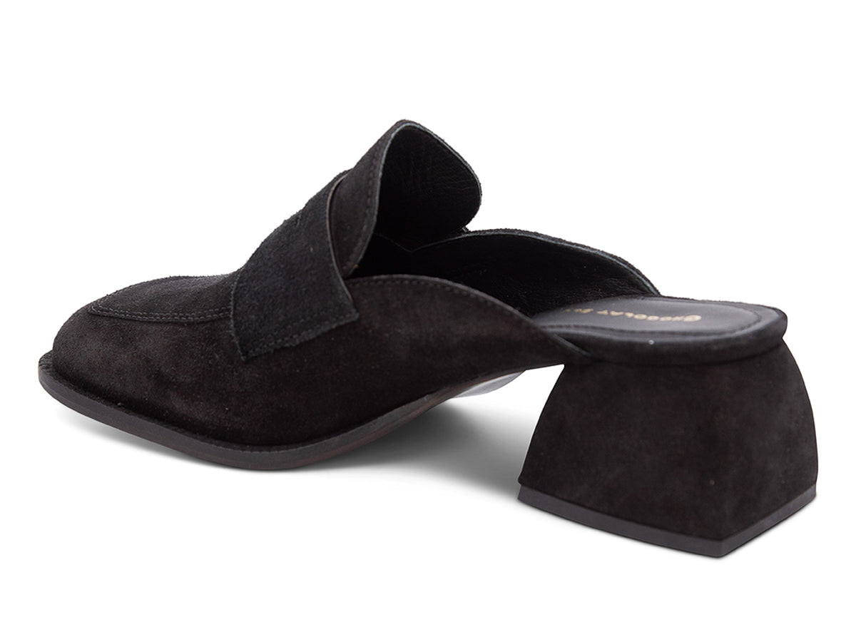 Black suede slide shoe with a block heel and penny loafer design on a white background side angle view