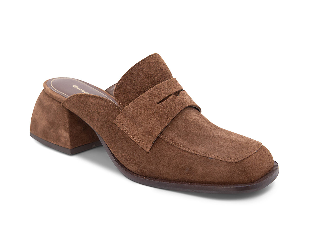 Brown suede slide shoe with a block heel and penny loafer design on a white background side angle view