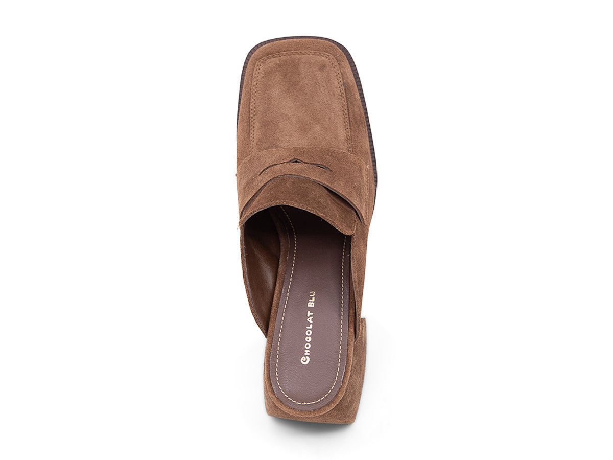 Brown suede slide shoe with a block heel and penny loafer design on a white background top view