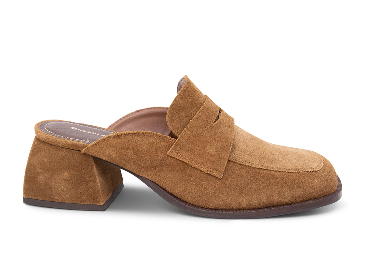 Camel suede slide shoe with a block heel and penny loafer design on a white background side view