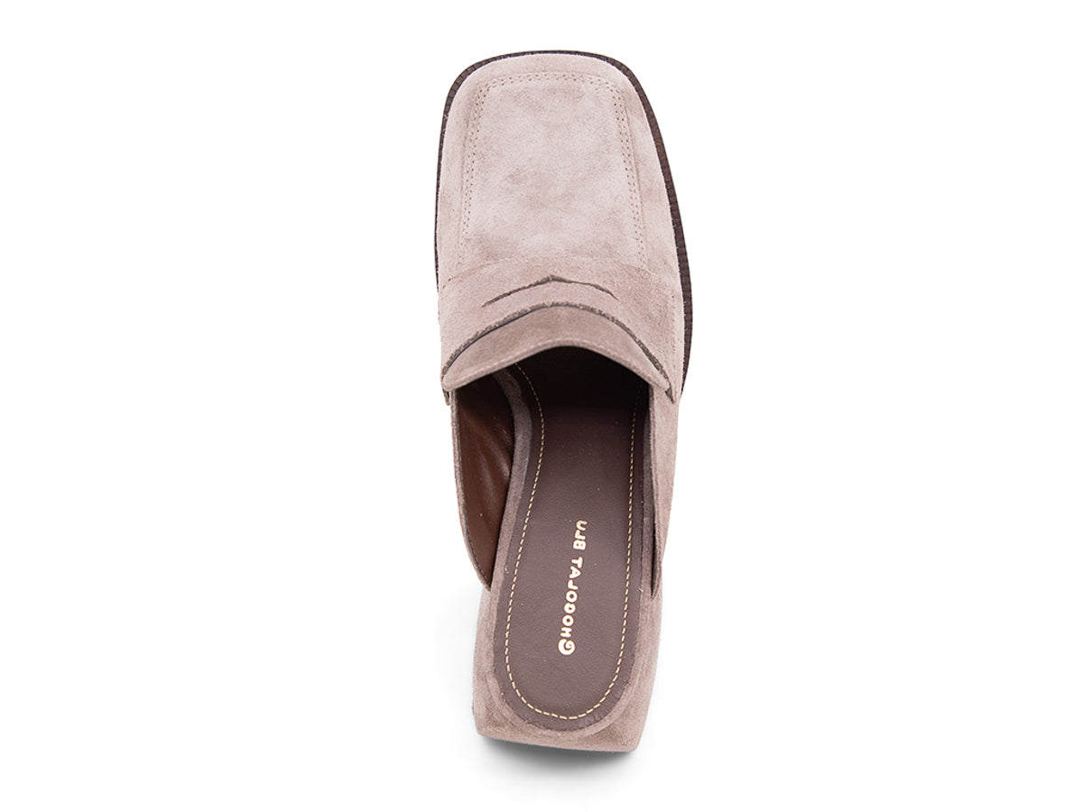 Fog (light grey) suede slide shoe with a block heel and penny loafer design on a white background top view