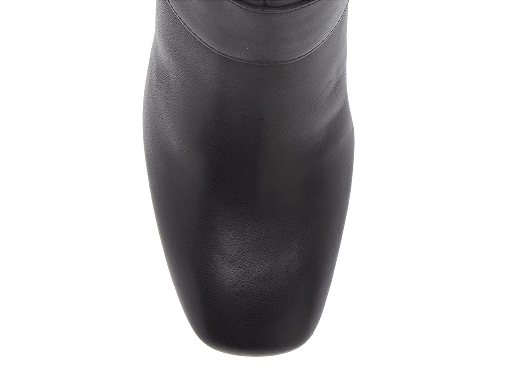 Black ankle heeled boot with gold buckle on a white background top toe view