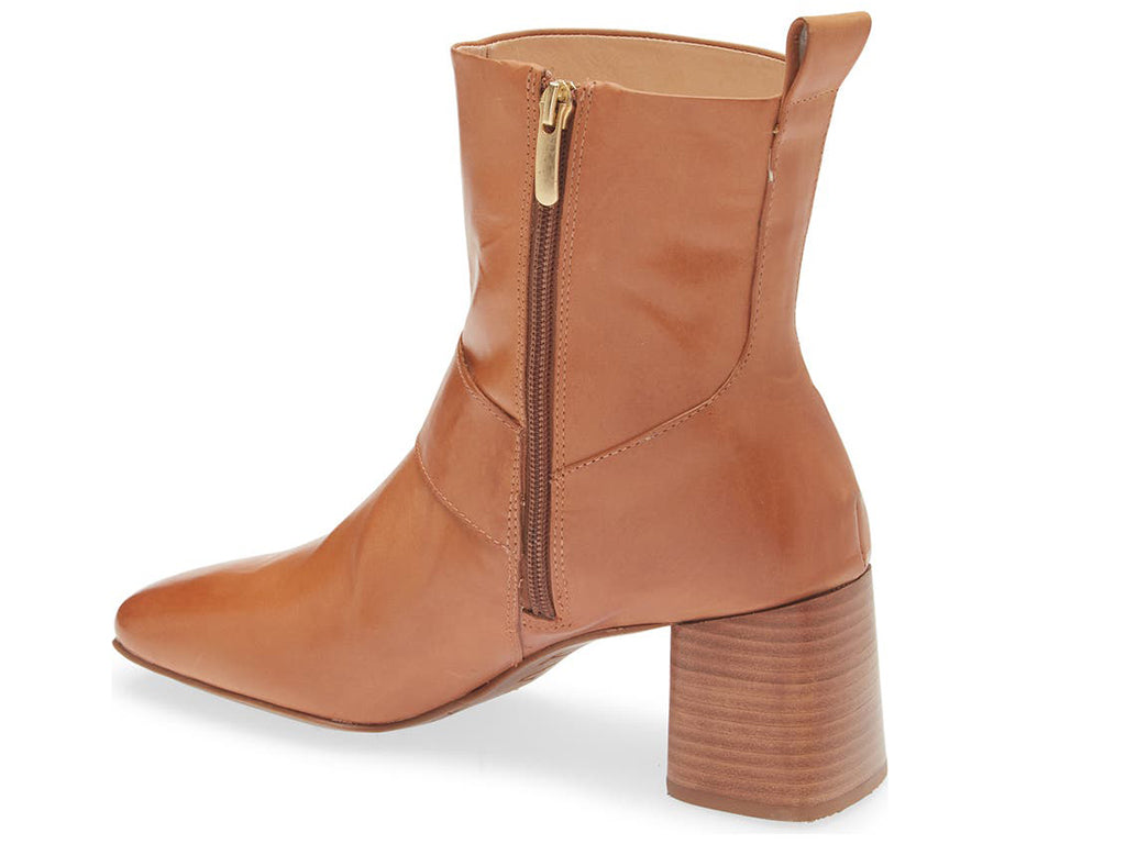 Camel ankle boot with gold buckle on a white background side angle view
