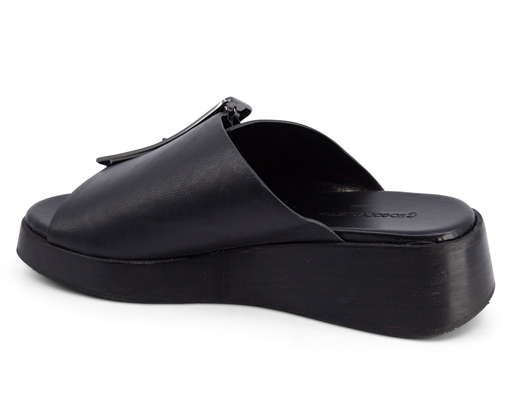 black wedge slide sandal with an oversized silver buckle - back angle view