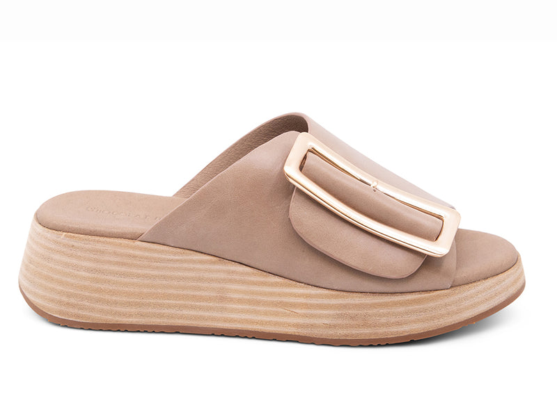 light khaki colored wedge slide sandal with oversized buckle - side view