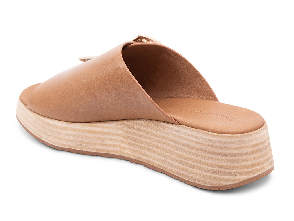 saddle colored wedge slide sandal with oversized buckle - back angle view