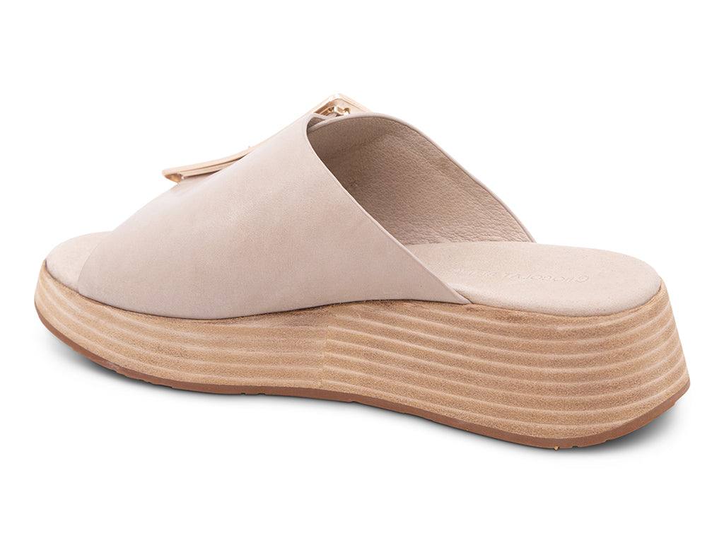 beige wedge slide sandal with an oversized gold buckle - back angle view