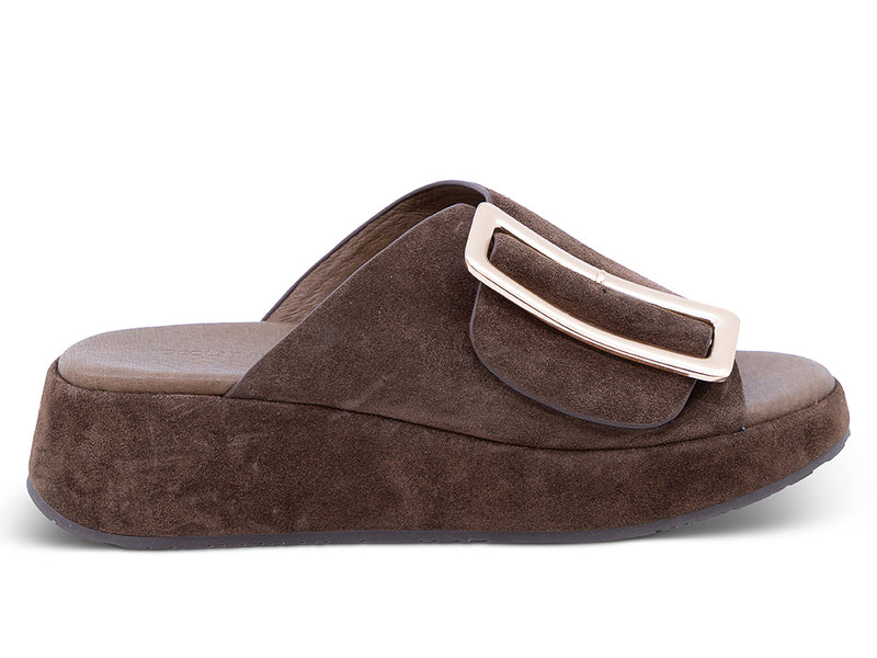a chocolate suede wedge slide sandal with a wide strap and an oversized buckle - lateral side view