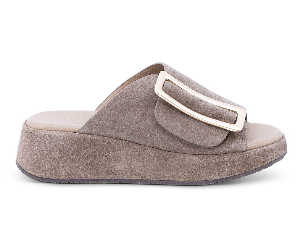 a dark taupe suede wedge slide sandal with a wide strap and an oversized buckle - lateral side view