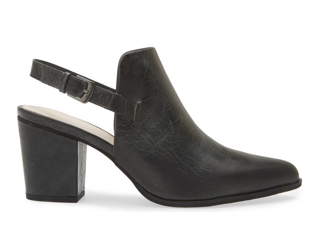 Black pointed toe shoe with block heel and buckle ankle back strap on a white background side view