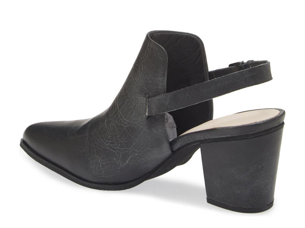 Black pointed toe shoe with block heel and buckle ankle back strap on a white background side angle view