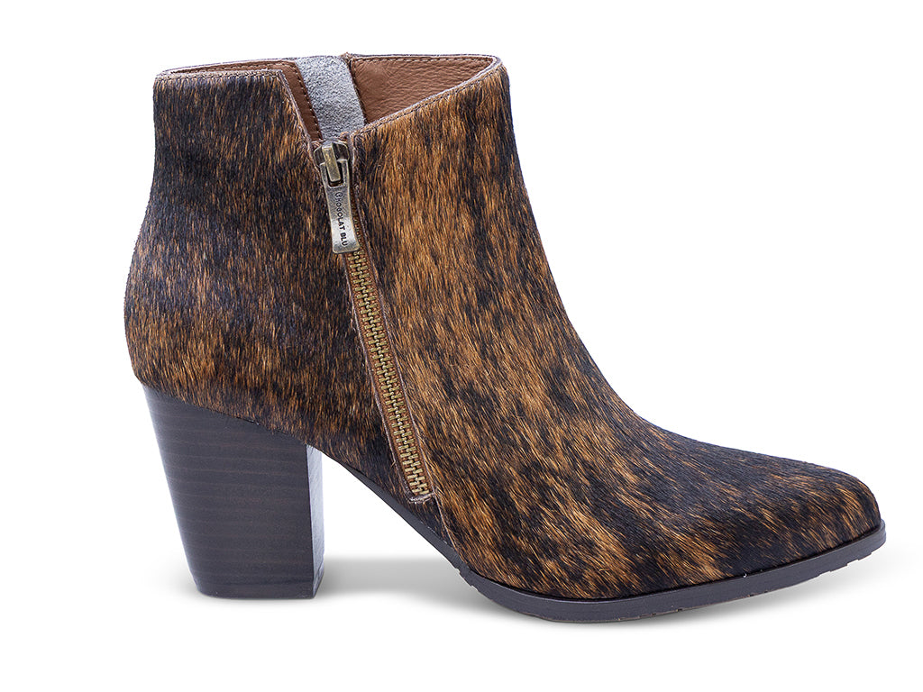 calf hair ankle boot with a brown and black mottled cowhide pattern, dark gray block heel, a pointed toe, and a side zipper -lateral side view