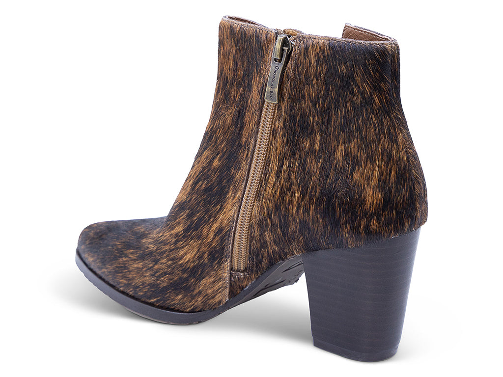 calf hair ankle boot with a brown and black mottled cowhide pattern, dark gray block heel, a pointed toe, and a side zipper - medial side view
