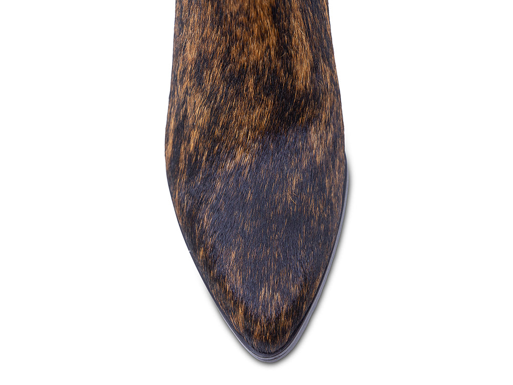 calf hair ankle boot with a brown and black mottled cowhide pattern, dark gray block heel, a pointed toe, and a side zipper - view of the toe shape