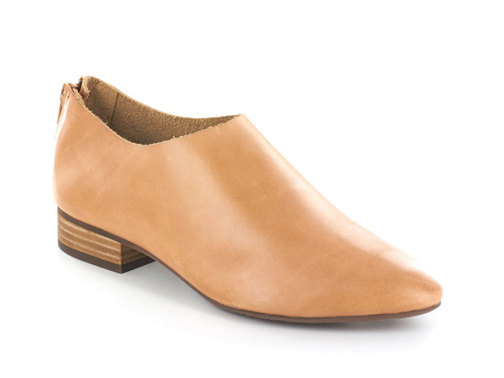 Camel leather pointed toe flat with mini block heel and back zipper on a white background side angle view