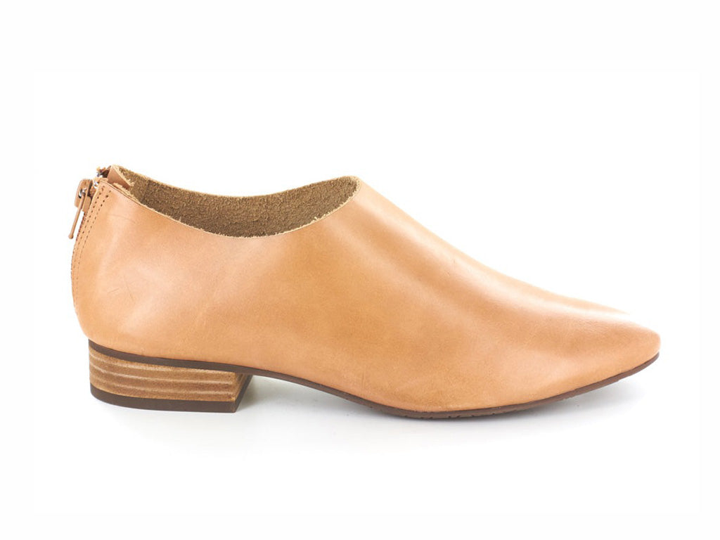 Camel leather pointed toe flat with mini block heel and back zipper on a white background side view