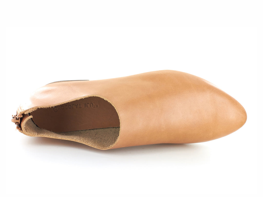 Camel leather pointed toe flat with mini block heel and back zipper on a white background side angle view