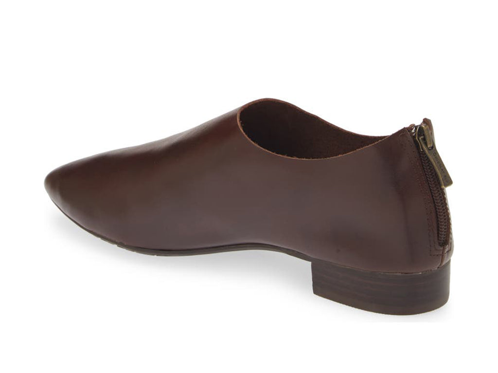 Dark Brown leather pointed toe flat with mini block heel and back zipper on a white background side angle view