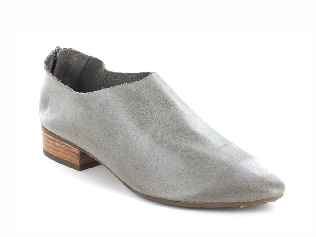 Grey leather pointed toe flat with mini block heel and back zipper on a white background side angle view