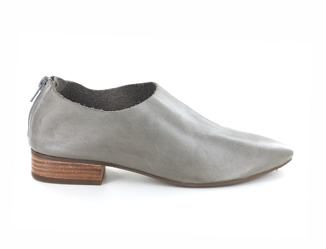Grey leather pointed toe flat with mini block heel and back zipper on a white background side view
