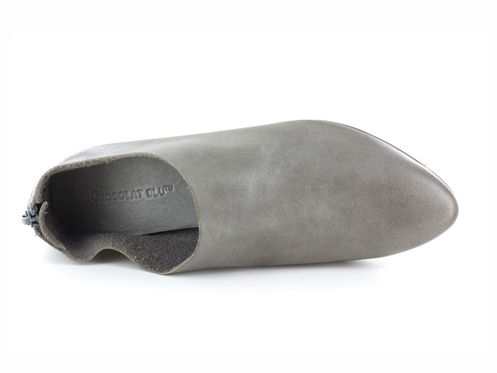 Grey leather pointed toe flat with mini block heel and back zipper on a white background top view