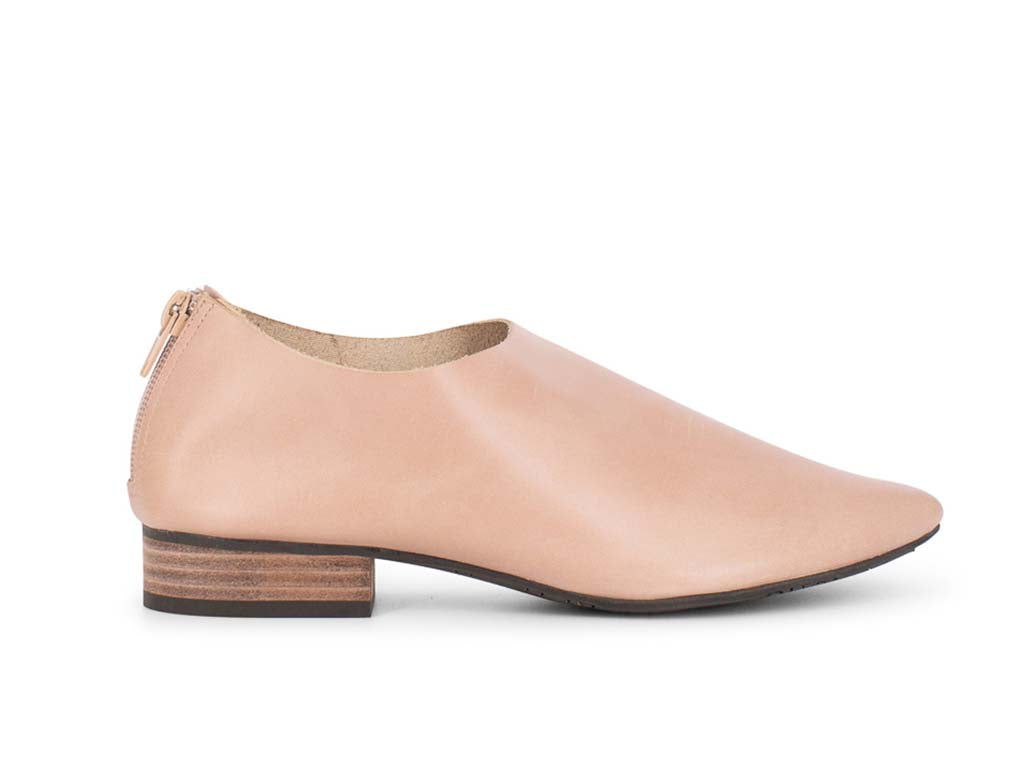 Latte leather pointed toe flat with mini block heel and back zipper on a white background side view