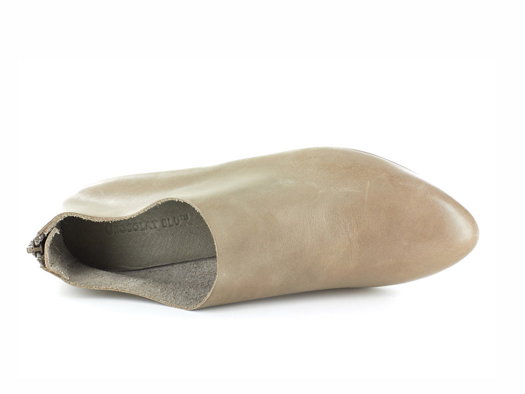 Taupe leather pointed toe flat with mini block heel and back zipper on a white background top view