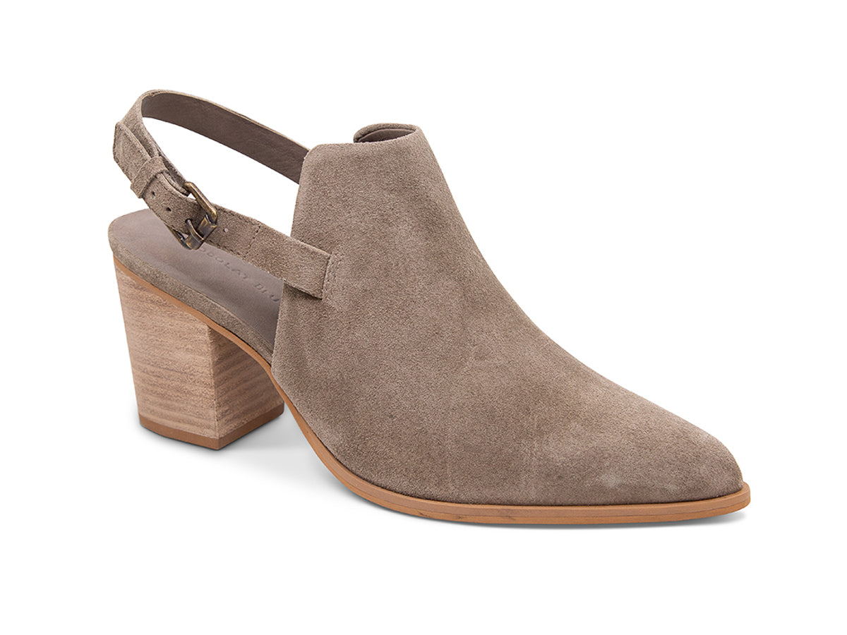 Taupe suede pointed toe shoe with wooden block heel and buckle ankle back strap on a white background side angle view
