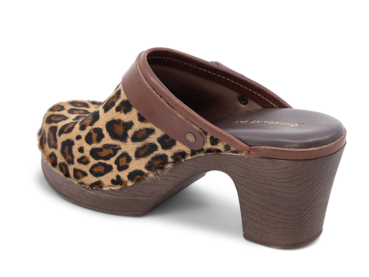 Leopard print heeled clog shoe with strap and buckle on a white background side angle view