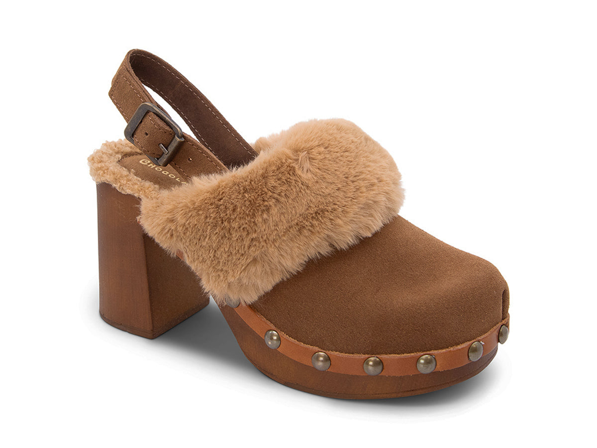 Brown heeled clog shoe with fur trim and grommet studs on a white side background side angle view